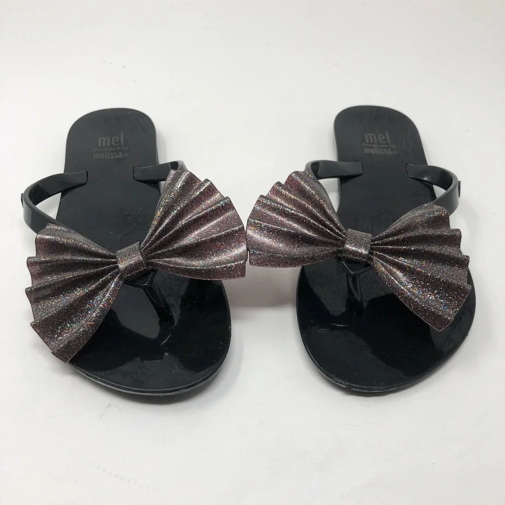 Melissa Mel Harmonic Bow Vi INF Flip Flops Girls 1 Black Glitter Scented